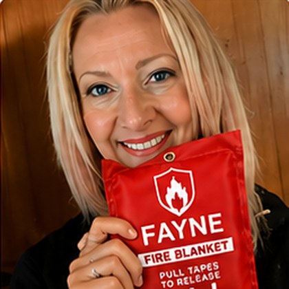 Fayne customer holding their fire blanket at home