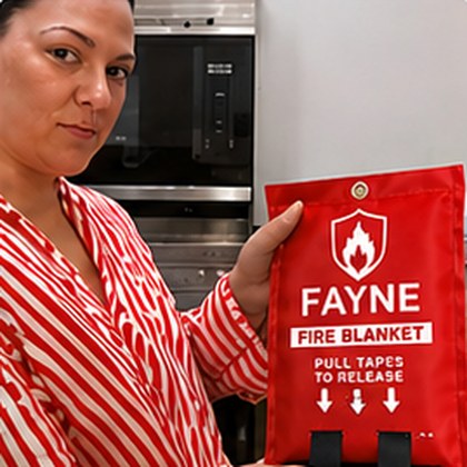 Fayne customer holding their fire blanket at home